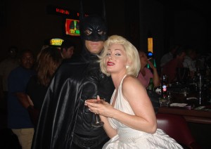 people in batman & marilyn monroe costumes