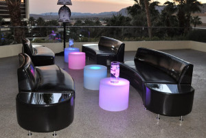 black couches and light up tables at corporate event