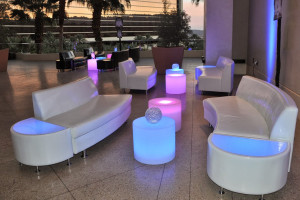 white couches and light up tables at corporate event